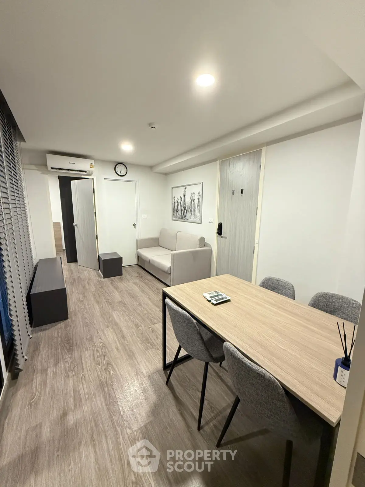 Modern living room with sleek furniture and wood flooring