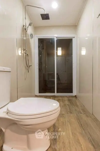 Modern bathroom with sleek shower and wooden flooring