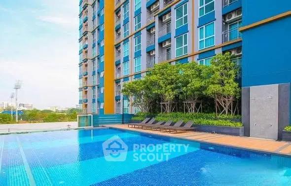 Luxurious high-rise building with stunning pool and lush greenery, perfect for modern urban living.
