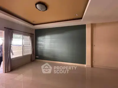 Spacious living room with large window and modern ceiling design