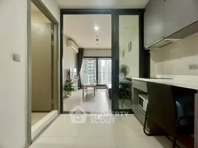 Modern apartment interior with sleek kitchen and spacious living area featuring city view.