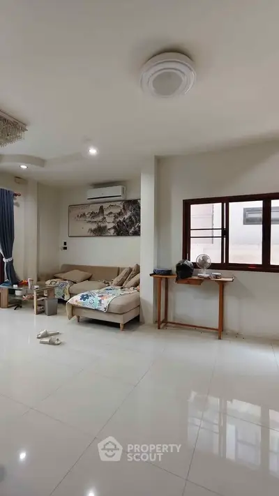 Spacious living room with modern decor and large window