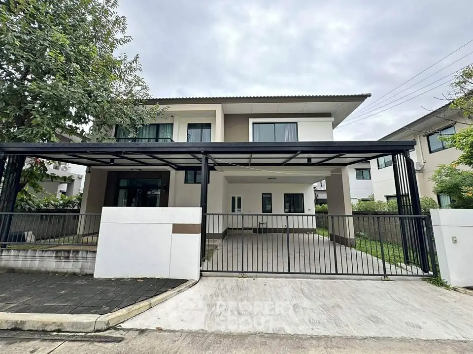 Modern two-story house with spacious driveway and sleek design in a suburban neighborhood.