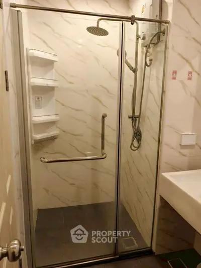 Modern bathroom with glass shower enclosure and sleek fixtures