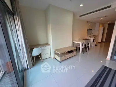Modern apartment interior with open layout, featuring a dining area and study nook, perfect for urban living.