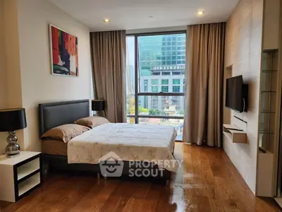 Luxurious bedroom with city view, modern decor, and elegant furnishings