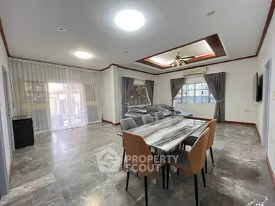 Spacious modern living room with elegant dining area and large windows for natural light.
