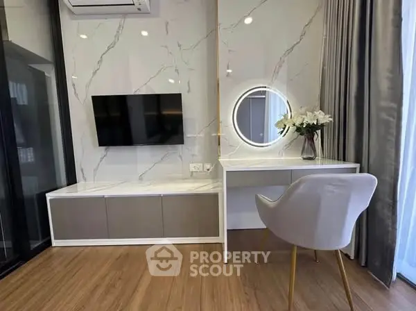 Modern living room with stylish TV setup and elegant vanity desk