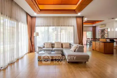 Spacious modern living room with elegant decor and large windows for natural light.