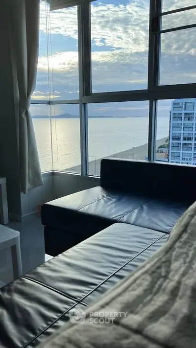 Stunning ocean view from modern living room with sleek furniture.