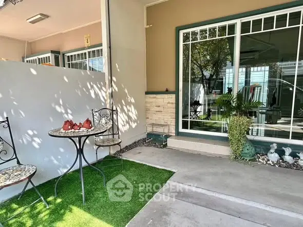 Charming garden patio with stylish outdoor seating and lush greenery.