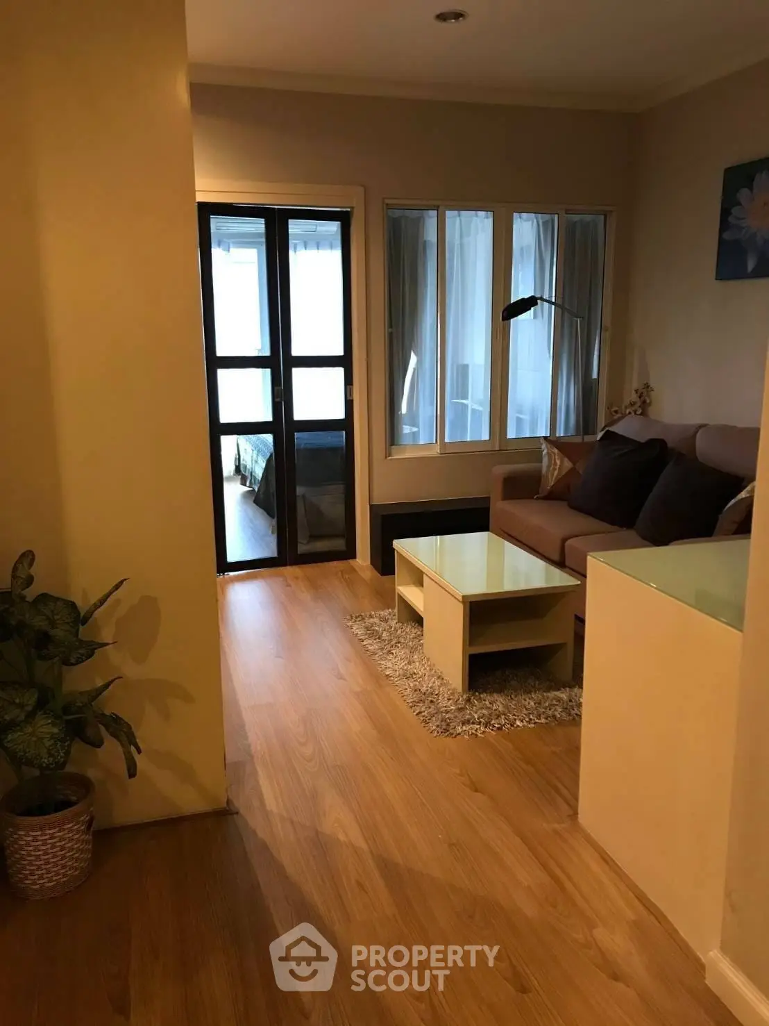 Cozy living room with wooden flooring and modern furniture in a stylish apartment.