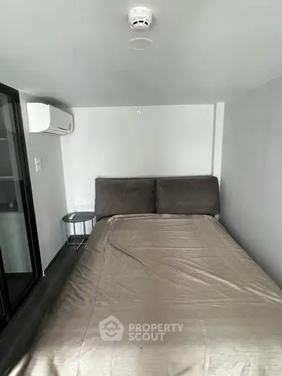 Cozy bedroom with modern air conditioning and sleek design, perfect for comfort and relaxation.