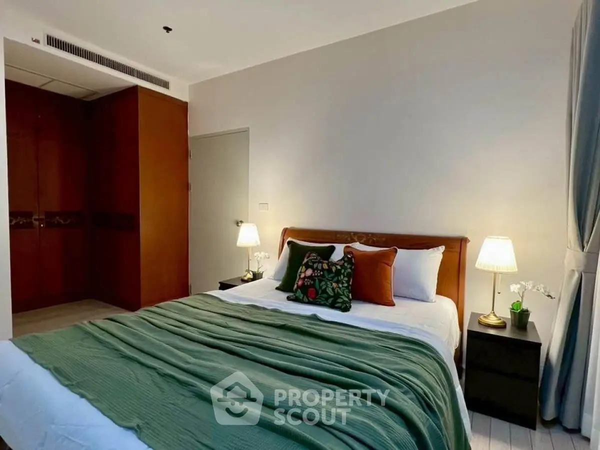 Cozy bedroom with elegant decor and ambient lighting, featuring a comfortable bed and stylish furnishings.