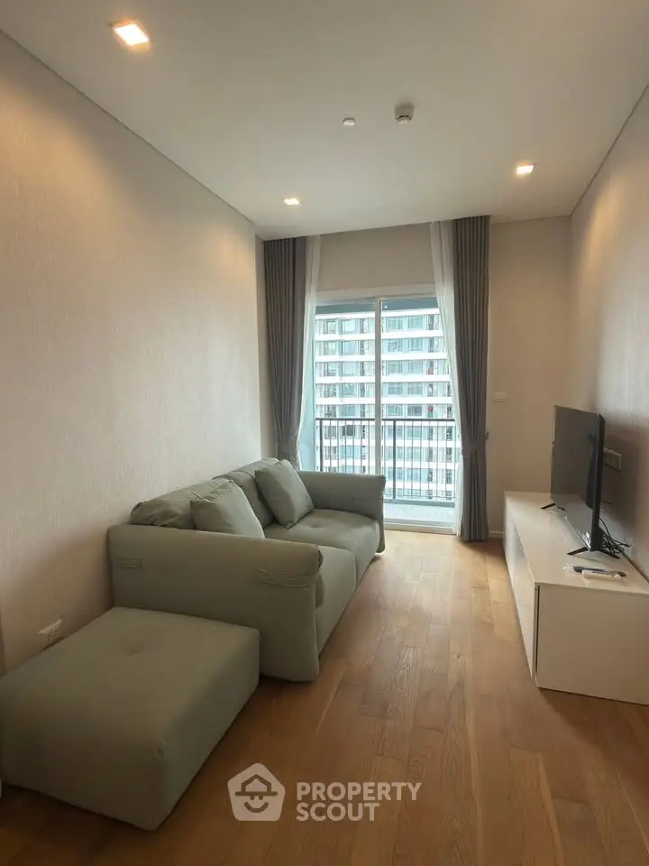 Modern living room with cozy sofa and large window offering city view