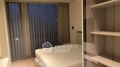 Modern bedroom with floor-to-ceiling windows and elegant curtains in a high-rise apartment.