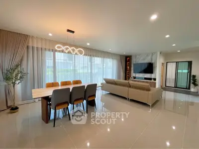 Spacious modern living room with elegant dining area and stylish lighting