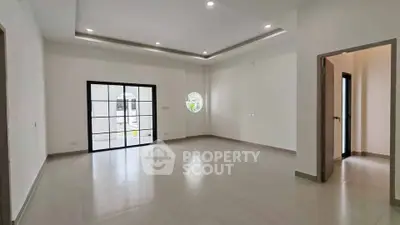 Spacious modern living room with large windows and elegant ceiling design