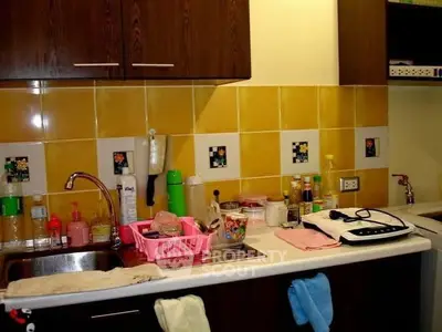 Cozy kitchen with vibrant yellow tiles and modern appliances