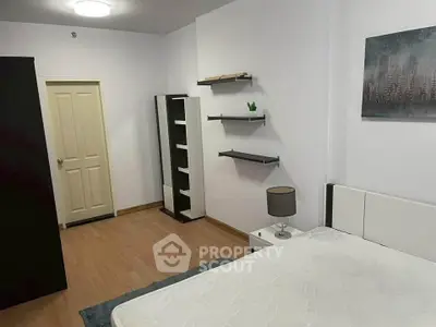 Spacious bedroom with modern decor and ample storage in a stylish apartment.