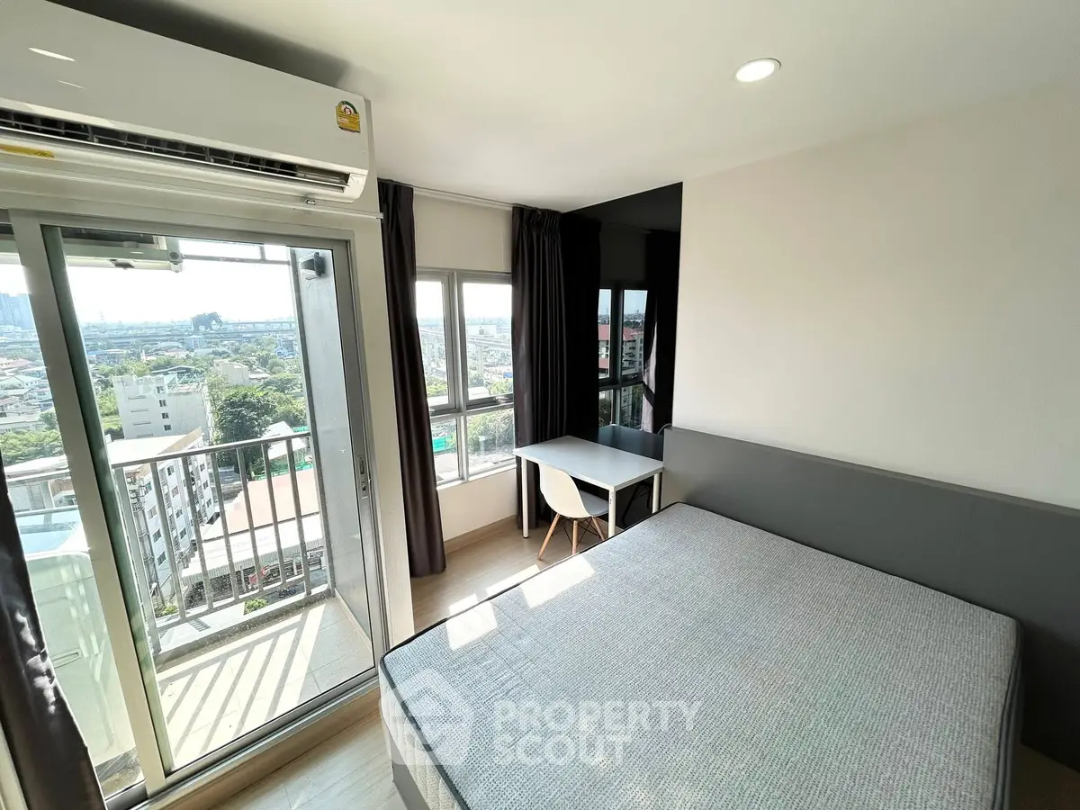 Modern bedroom with balcony and stunning city view in high-rise apartment