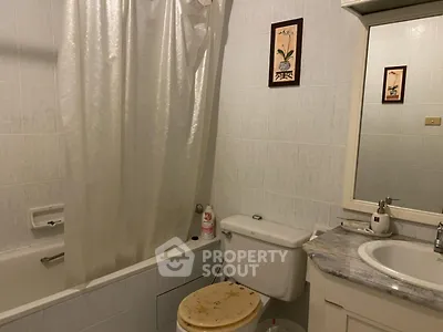Cozy bathroom with bathtub and elegant decor, perfect for relaxation.