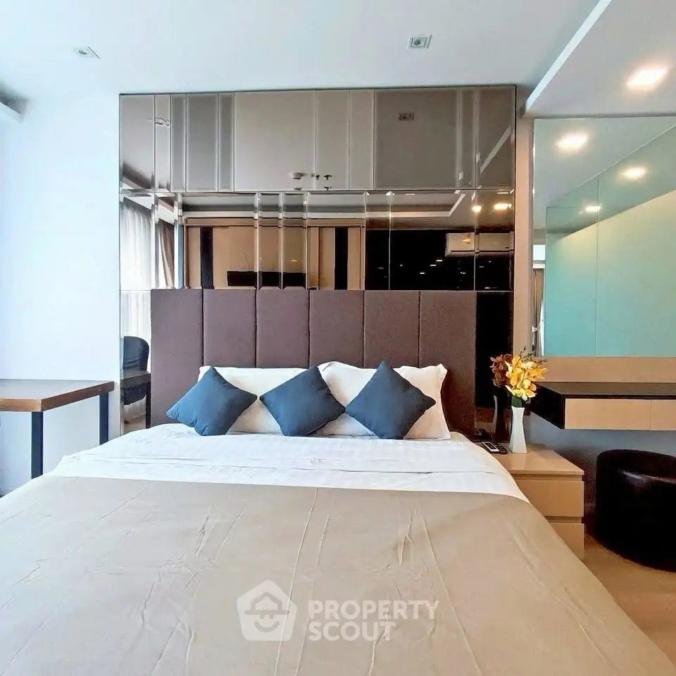 Luxurious modern bedroom with stylish decor and plush bedding in a high-end apartment.