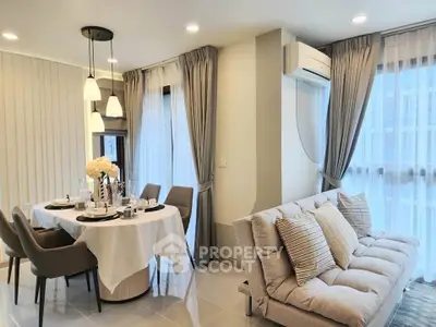 Modern living room with elegant dining area, featuring stylish furniture and large windows for natural light.