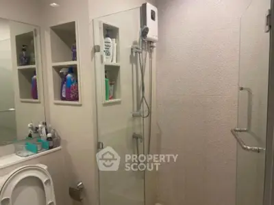 Modern bathroom with glass shower and built-in shelves