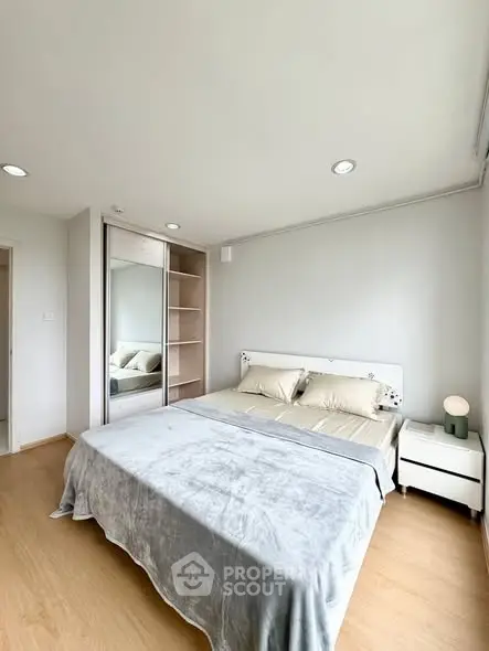 Spacious bedroom with modern decor and ample natural light