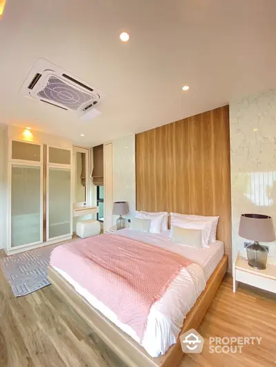 Modern bedroom with stylish decor and wooden accents, featuring a cozy bed and ambient lighting.