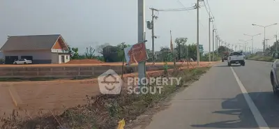 Spacious roadside property with potential for development, featuring a single-story building and ample land space.