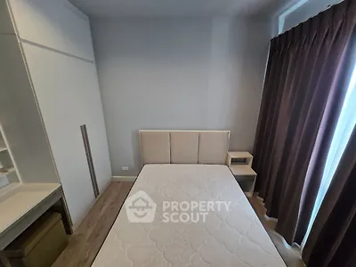 Cozy bedroom with modern furniture and natural light, perfect for relaxation.