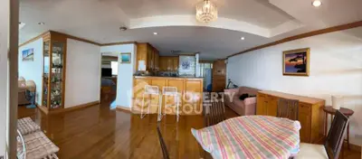 Spacious open-plan living and dining area with wooden flooring and modern decor.
