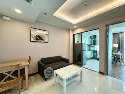 Modern living room with open kitchen and stylish furniture in a bright apartment.