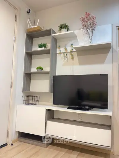 Modern living room with stylish TV unit and decorative shelves
