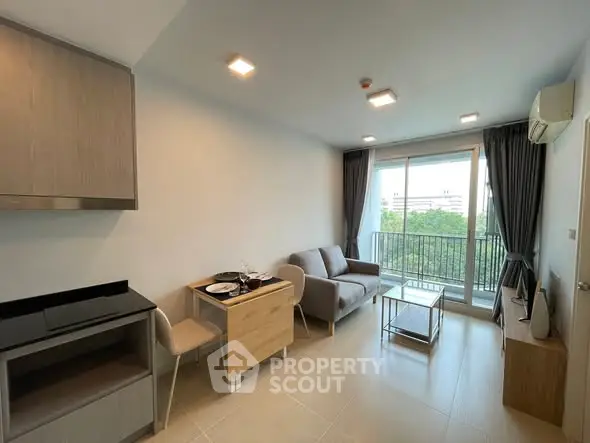Modern living room with balcony view and stylish furniture in a bright apartment.