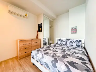 Cozy bedroom with modern decor and ample natural light