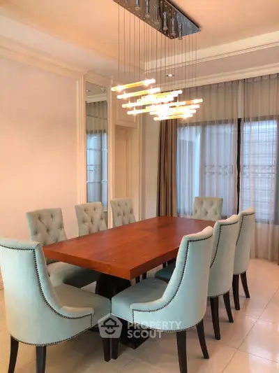 Elegant dining room with modern chandelier and plush seating