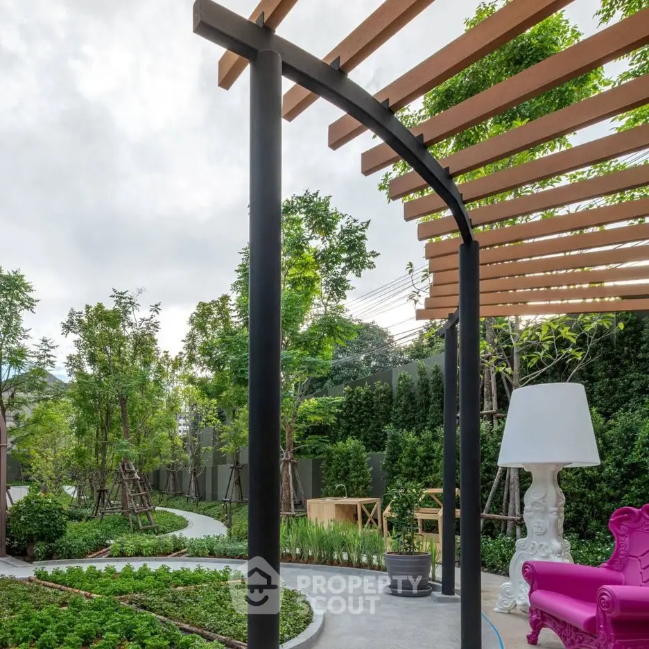 Charming garden with modern pergola and vibrant pink chair, perfect for relaxation.