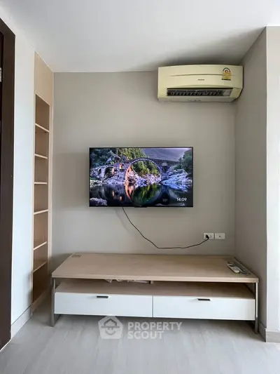 Modern living room with wall-mounted TV and air conditioning unit