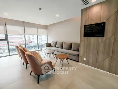 Modern living room with stylish furniture and large windows offering natural light.