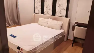Modern bedroom with stylish decor and comfortable bed in a cozy apartment.