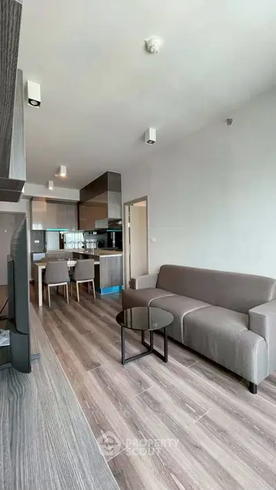 Modern open-layout living room with sleek kitchen and stylish furniture