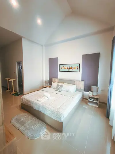 Spacious modern bedroom with elegant decor and natural light