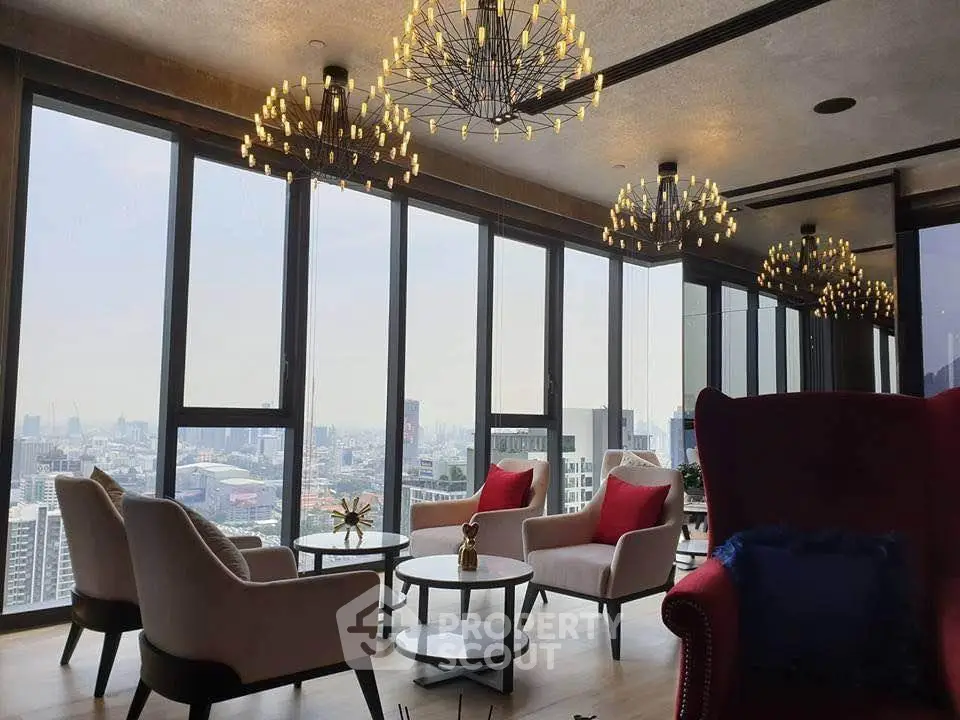 Luxurious high-rise living room with panoramic city views and elegant chandeliers.