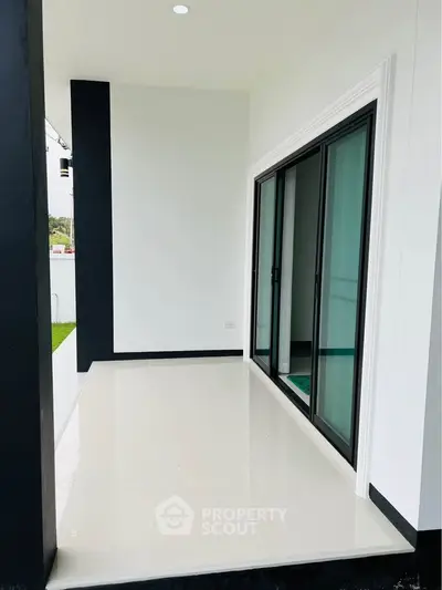 Modern balcony with sleek sliding glass doors and minimalist design