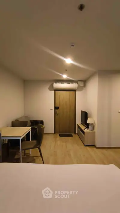 Modern studio apartment with cozy living area and sleek furniture
