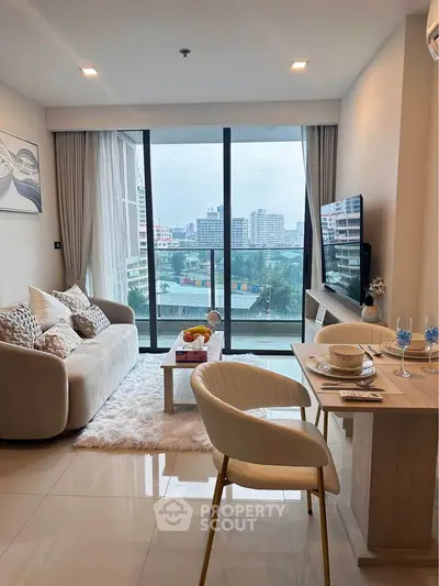 Modern living room with city view, elegant decor, and cozy seating area.
