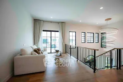 Spacious living room with modern decor and large windows for natural light.